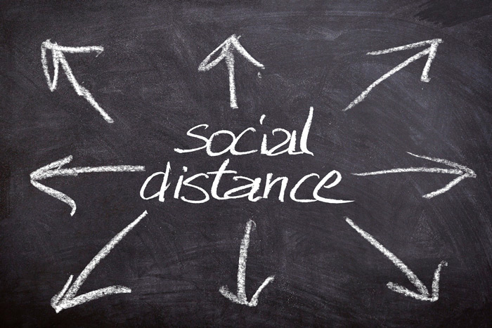 Social distance written on a blackboard